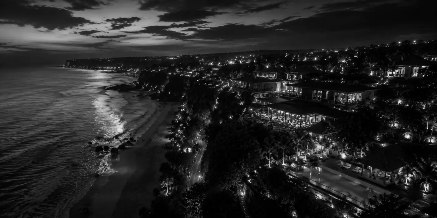 Black-and-white aerial view of the Bali coastline at night