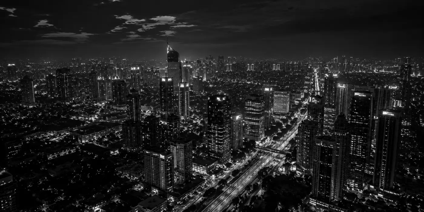 Black-and-white aerial view of the Jakarta skyline at night